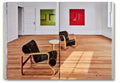 Open art book titled "Donald Judd Spaces" by Judd Foundation, showcasing images of minimalist architectural designs and interior spaces.